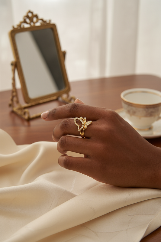 Woman wearing gold butterfly and crown ring